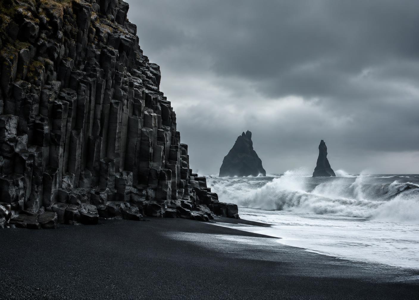 Basalt columns and crashing surf on an Icelandic black sand beach